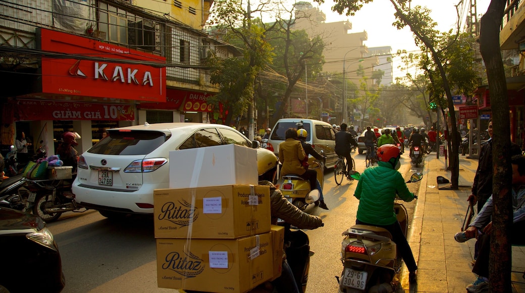 Hanoi which includes a city, motorbike riding and signage