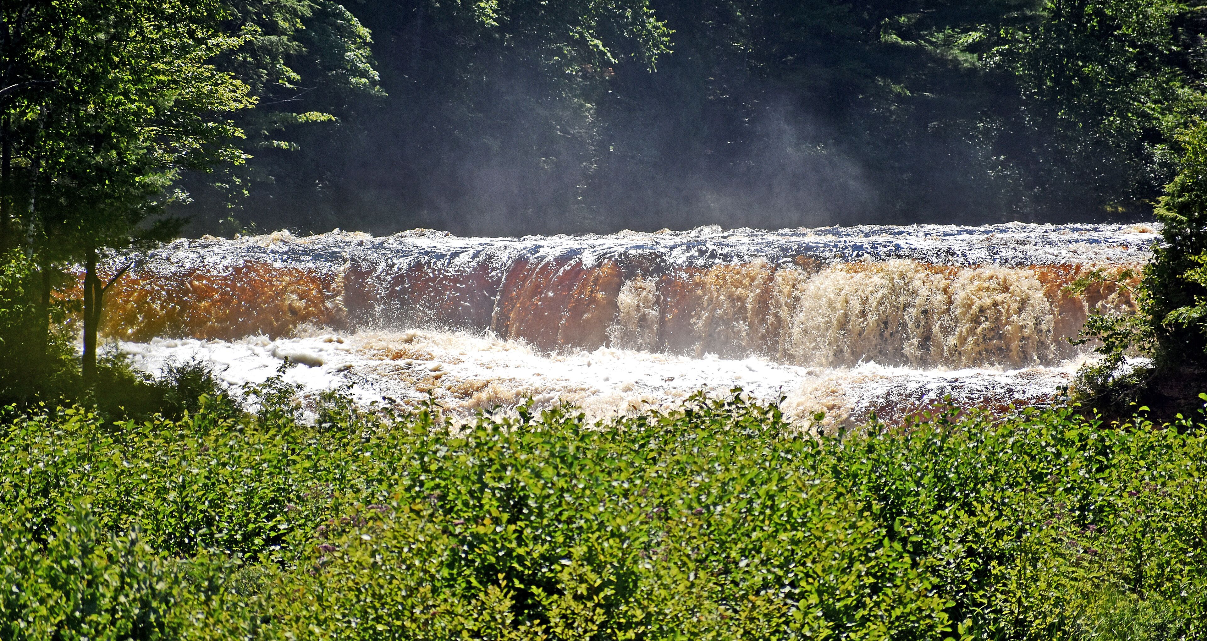 The lower falls are a series of cascades, that go around a small island, with several drops in the 10 foot range. You can rent a boat and go to the island, and walk around and see more views of the falls.