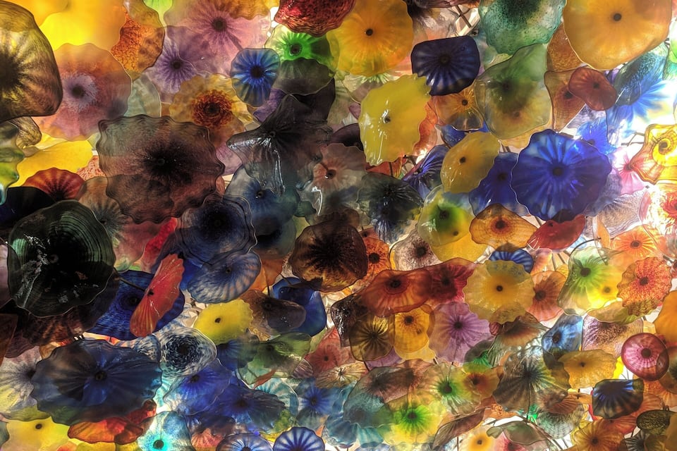 A colorful glass ceiling with various shapes and patterns.