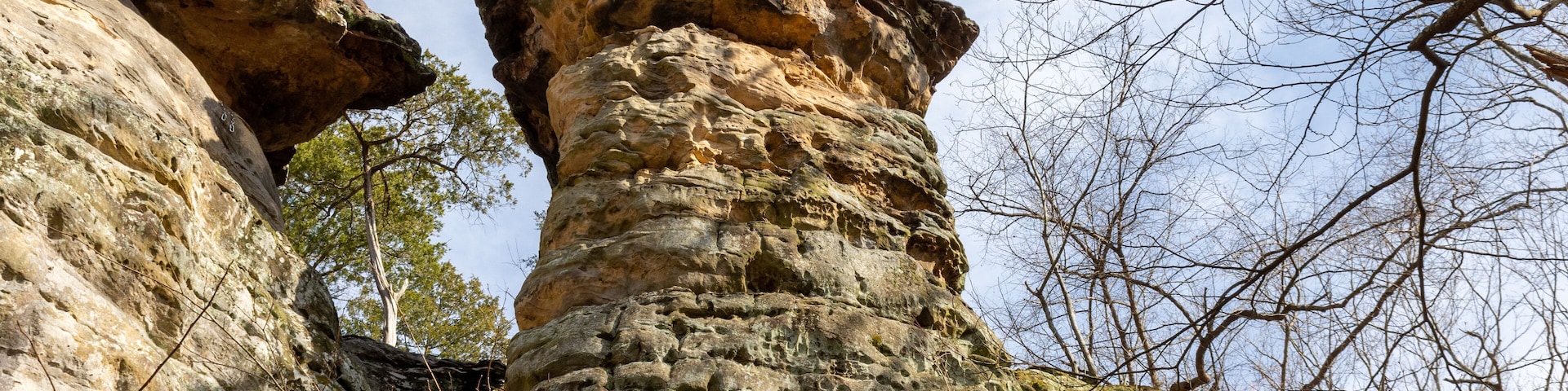 A rocky cliff formation with a prominent vertical rock protrusion.