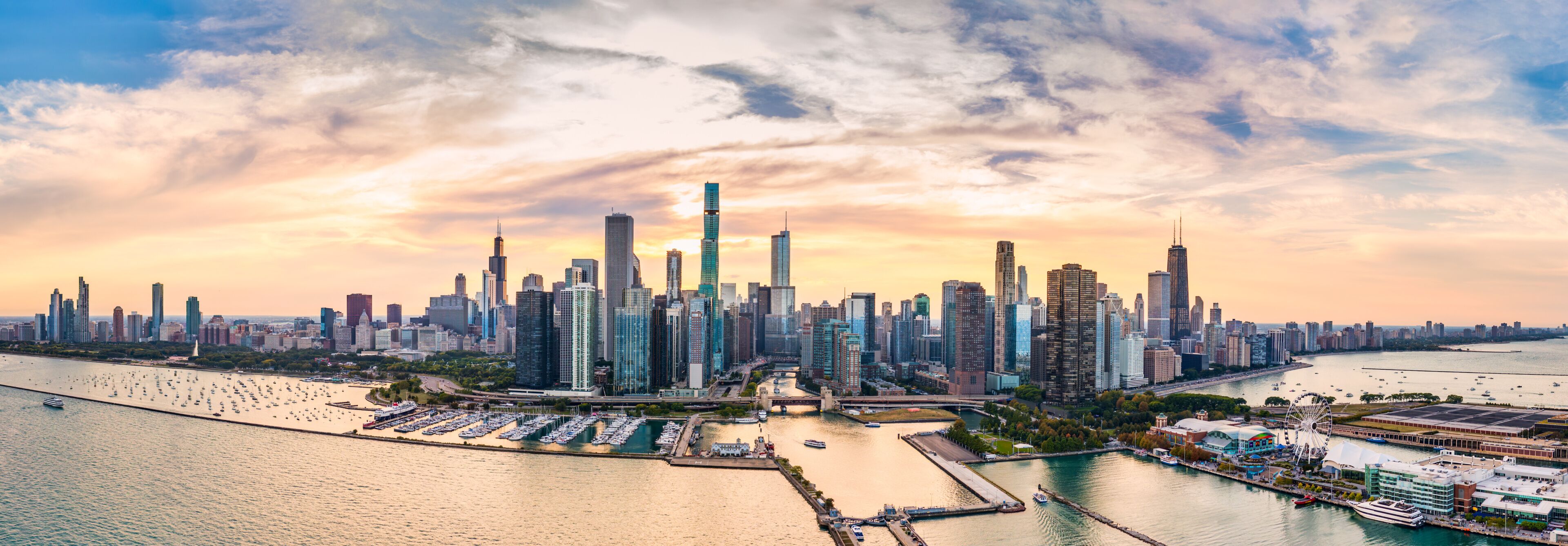 A city skyline with a prominent skyscraper, a marina with boats, and a river.
