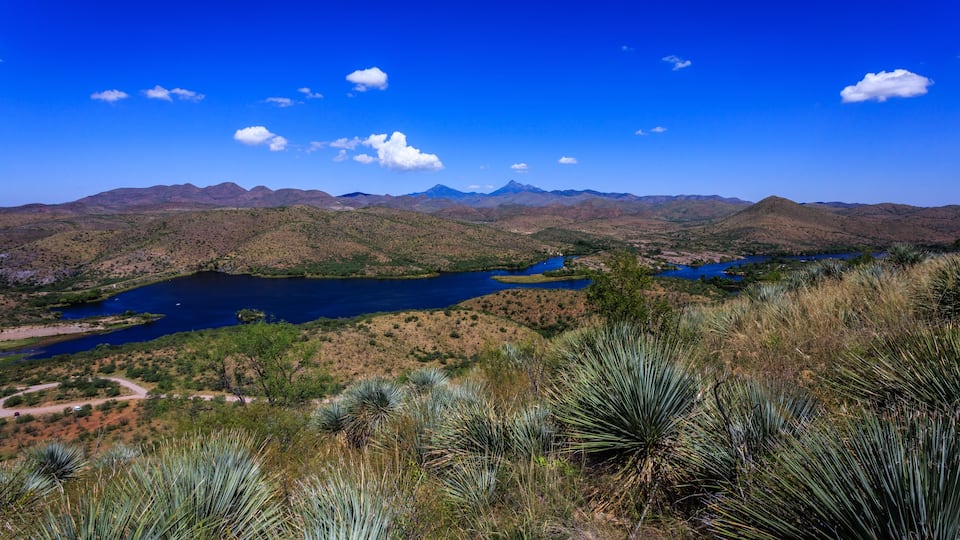 A mountainous landscape with a lake and sparse vegetation.