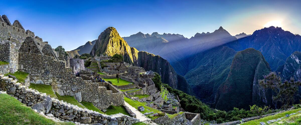 Machu Picchu ruins with Inca stone walls, terraced fields, and mountain backdrop.