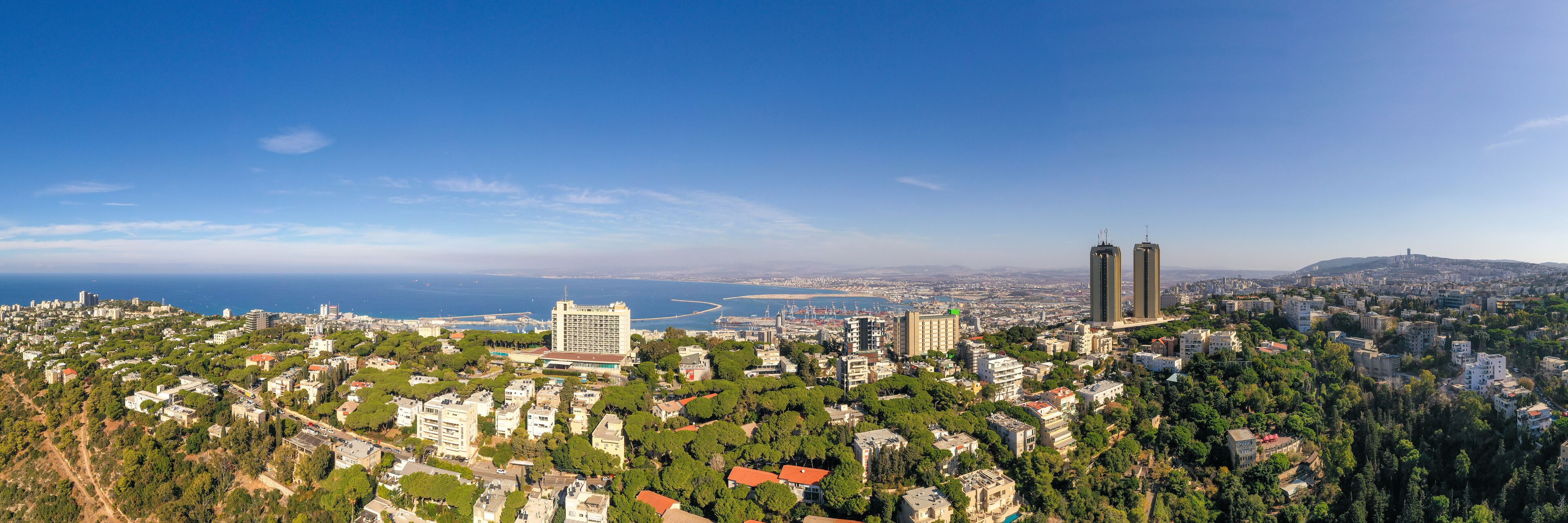 Aerial image of Haifa, Israel, showing houses on central Carmel area with Haifa bay in the background.