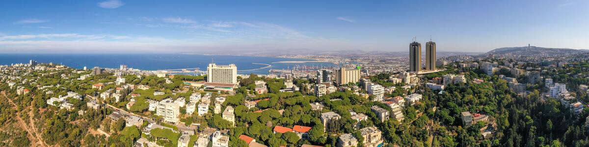Aerial image of Haifa, Israel, showing houses on central Carmel area with Haifa bay in the background.