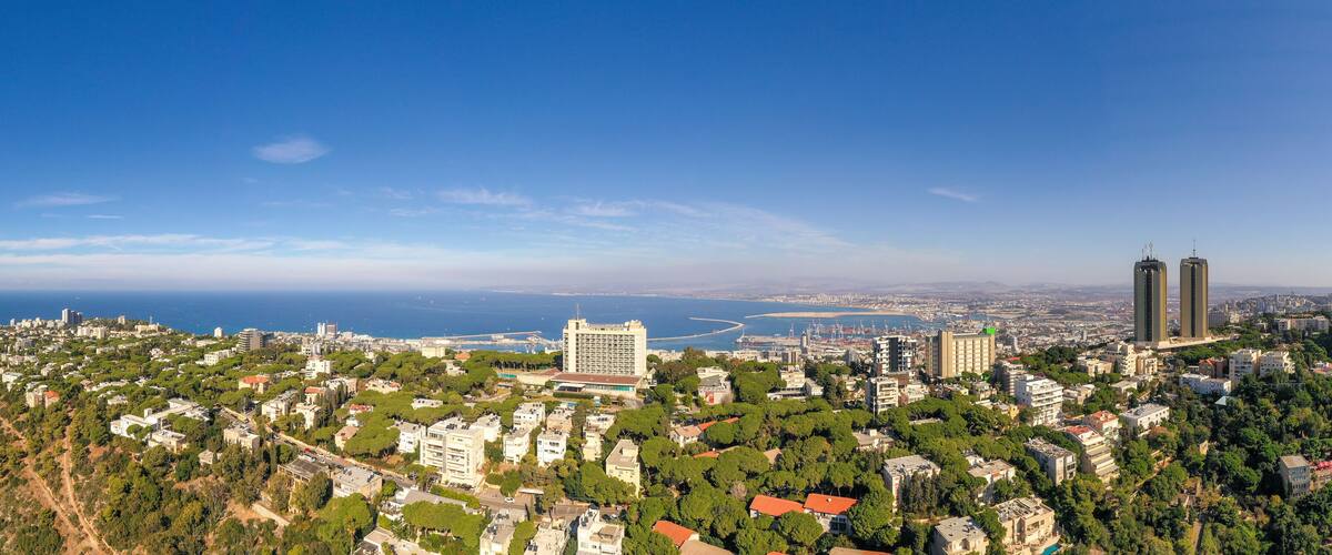 Aerial image of Haifa, Israel, showing houses on central Carmel area with Haifa bay in the background.