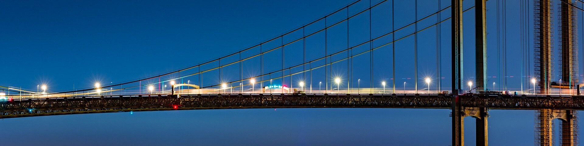 Wilmington skyline framed by Delaware Memorial Bridge, viewed from New Jersey, across the Delaware River. Wilmington is the largest city in the state of Delaware.