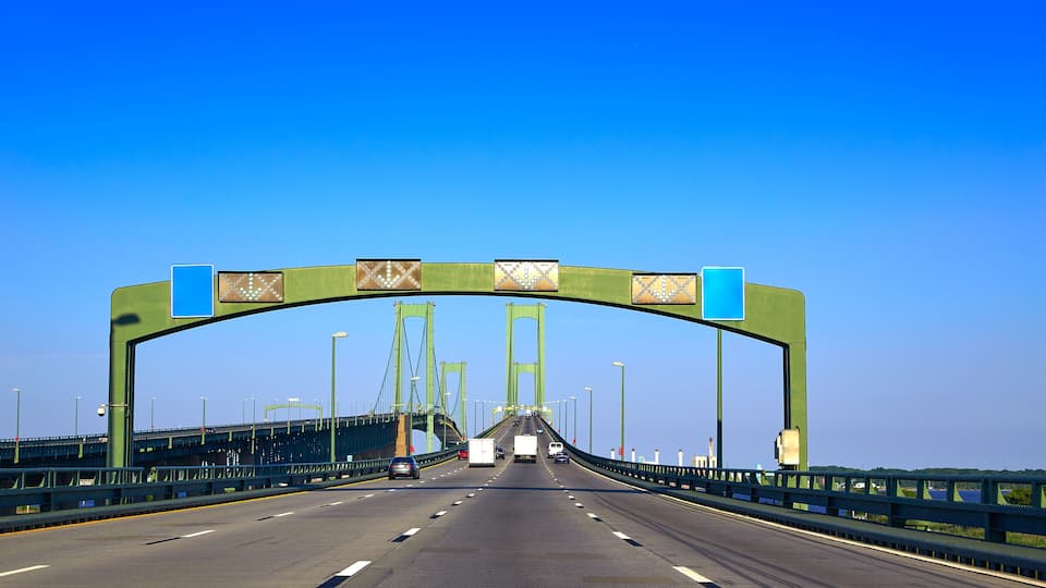 A green bridge with a clear blue sky.