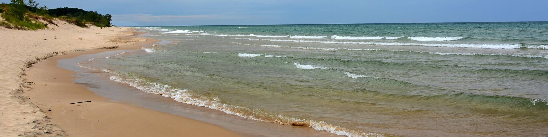 the picturesque beach next to the little sable point lighthouse in silver lake state park on lake michigan, in mears, michigan