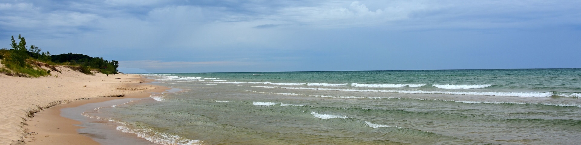 the picturesque beach next to the little sable point lighthouse in silver lake state park on lake michigan, in mears, michigan