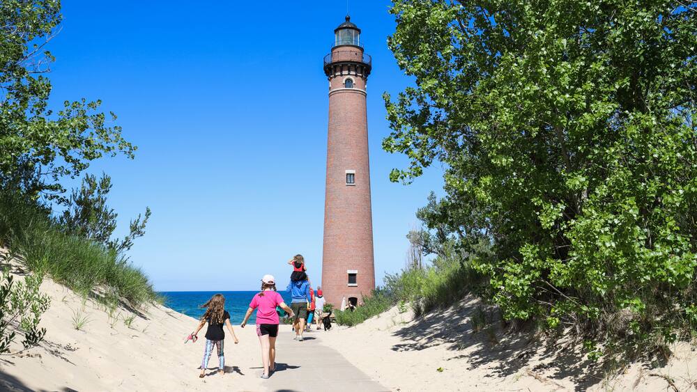 People walking to see Little Sable Point Lighthouse on Lake Michigan