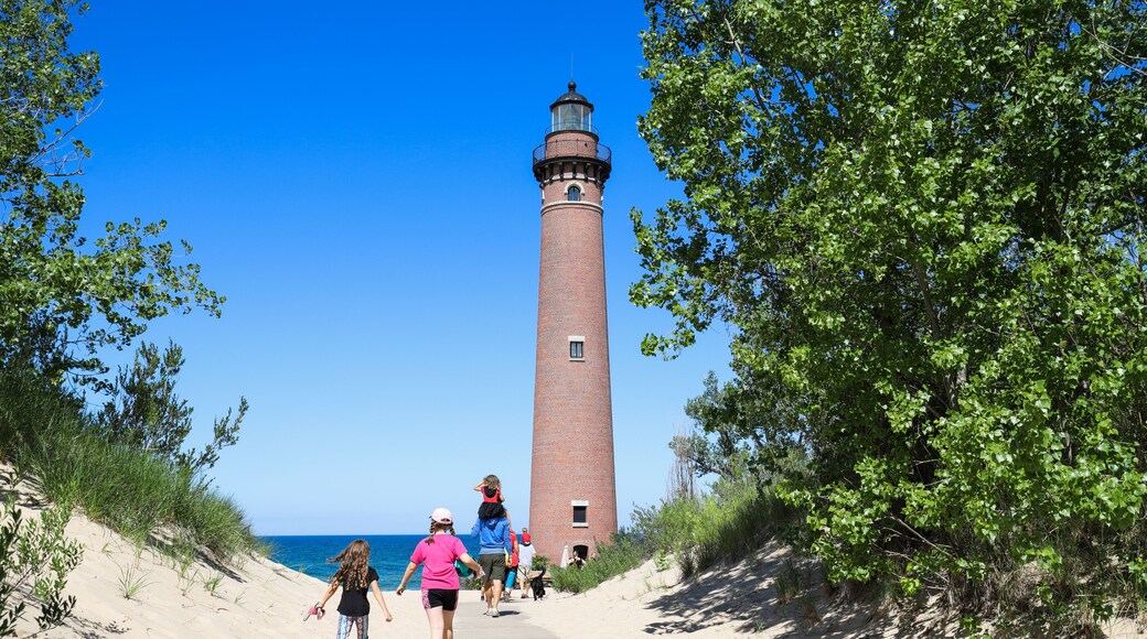 People walking to see Little Sable Point Lighthouse on Lake Michigan