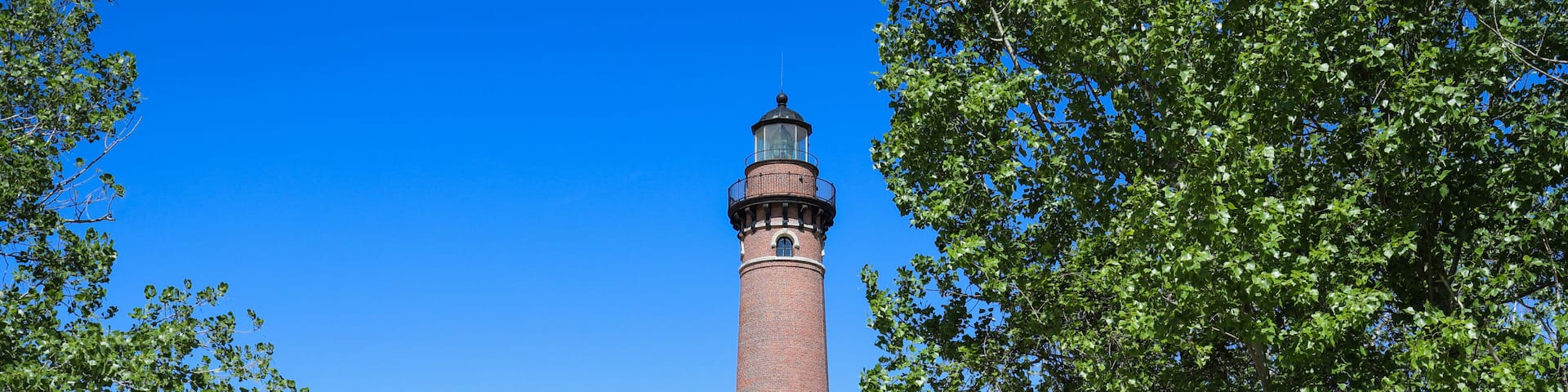 People walking to see Little Sable Point Lighthouse on Lake Michigan