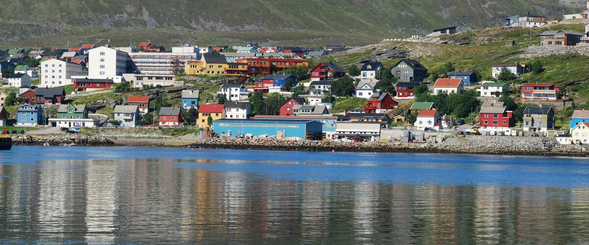 A coastal town with colorful houses and a rocky shoreline.