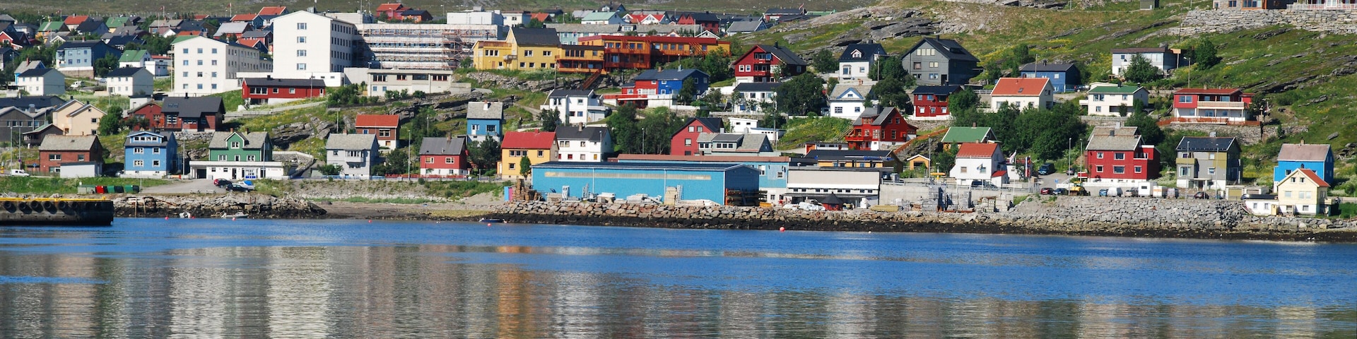 A coastal town with colorful houses and a rocky shoreline.