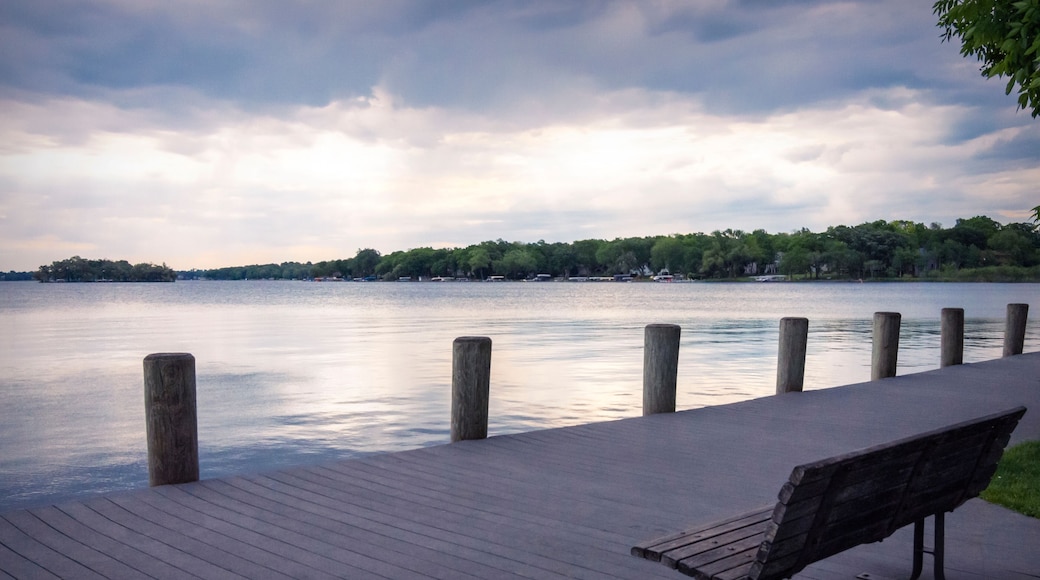A lone bench looks out onto Pewaukee Lake in Waukesha County, Wisconsin, on a gray, cloudy morning.