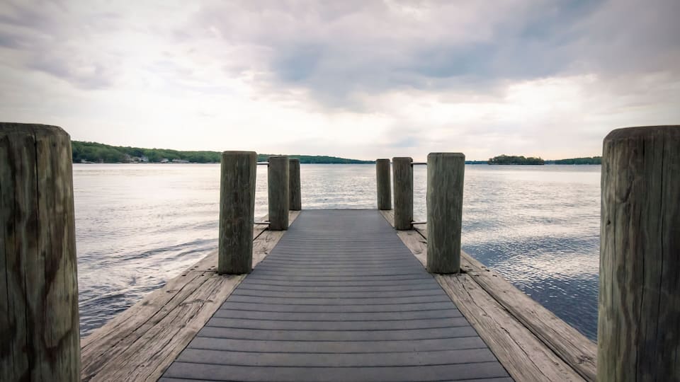 Looking down a boat pier on a cloudy morning on Pewaukee Lake in Waukesha County, Wisconsin.