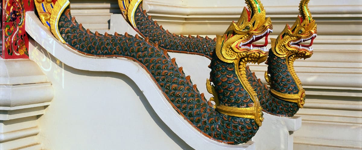 A detailed dragon sculpture with ornate gold and green decorations.