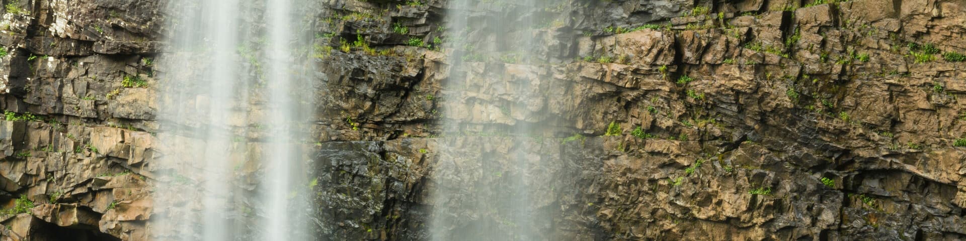 A woman and daughter hikiing below waterfall in Fall Creek Falls State Park, Pikeville, Tennesee.
