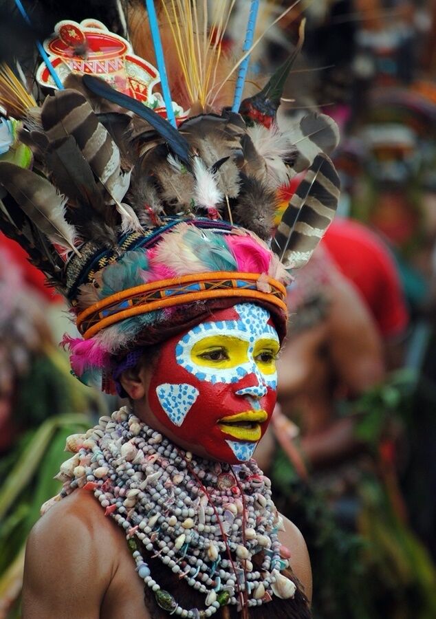 At the annual Sing Sing. The head dresses are made "on the day" composed of feathers from local birds. Each tribe paints their face with a distinctive design.

Jewellery is local shells and nuts.

