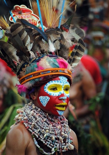 At the annual Sing Sing. The head dresses are made "on the day" composed of feathers from local birds. Each tribe paints their face with a distinctive design.
Jewellery is local shells and nuts.
