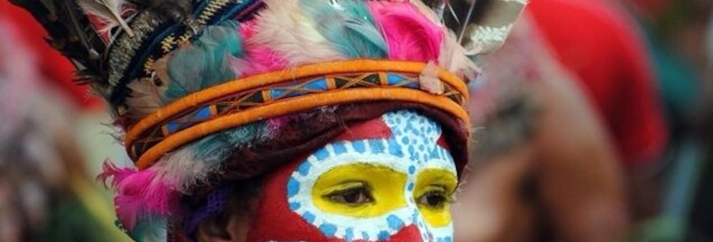 At the annual Sing Sing. The head dresses are made "on the day" composed of feathers from local birds. Each tribe paints their face with a distinctive design.
Jewellery is local shells and nuts.