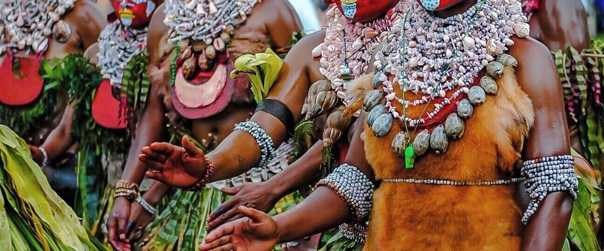 After travelling to over 50 countries in the last few years, there has been nothing that has had an impact on me as much as the Mount Hagen Sing Sing in Papua New Guinea.
Every year, 50 to 100 different tribes arrive early in the morning to an open field. There, they don their face paint, beads, shell necklaces, grass skirts, and drums.
Most importantly they construct their elaborate headresses on site. For example, the Simbu Traditional headress is one of the most colorful traditional headdreses in the Highland Region. The front feathers are from the red parrot feathers. The green ones in the middle are from green parrots feathers and on the top are the Stephanie’s Astrapia Bird of Paradise feathers.
When all these feathers are put into place they are tightened by a headband made of bamboo or bush veins and decorated by cuscus fur or sometimes cassowary feathers.
In Simbu tradition the Headdress plays a virtual role of identifying the status of a dancer in the society. The wealthy family is the one with more feathers and has the attractive headdress decorations.
At noon, they enter the parade grounds. They beat their drums, chant, sing and march around the open field. Visitors are allowed to get “up and personal” and take as many photos as they wish.
You’ll often see people lying on the ground to get a good shot of the headdress, only because they are often 3 ft. tall.
It’s an amazing site!
#FindingtheUniverse