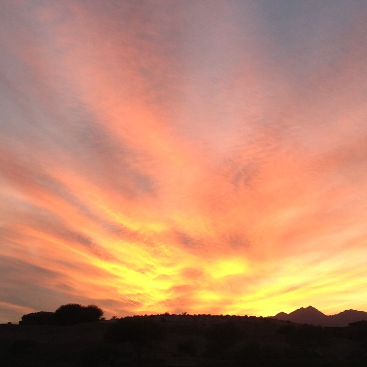 A sunset with a sky filled with orange and yellow hues.
