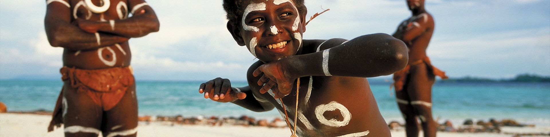 Honiara showing indigenous culture and a sandy beach as well as an individual child