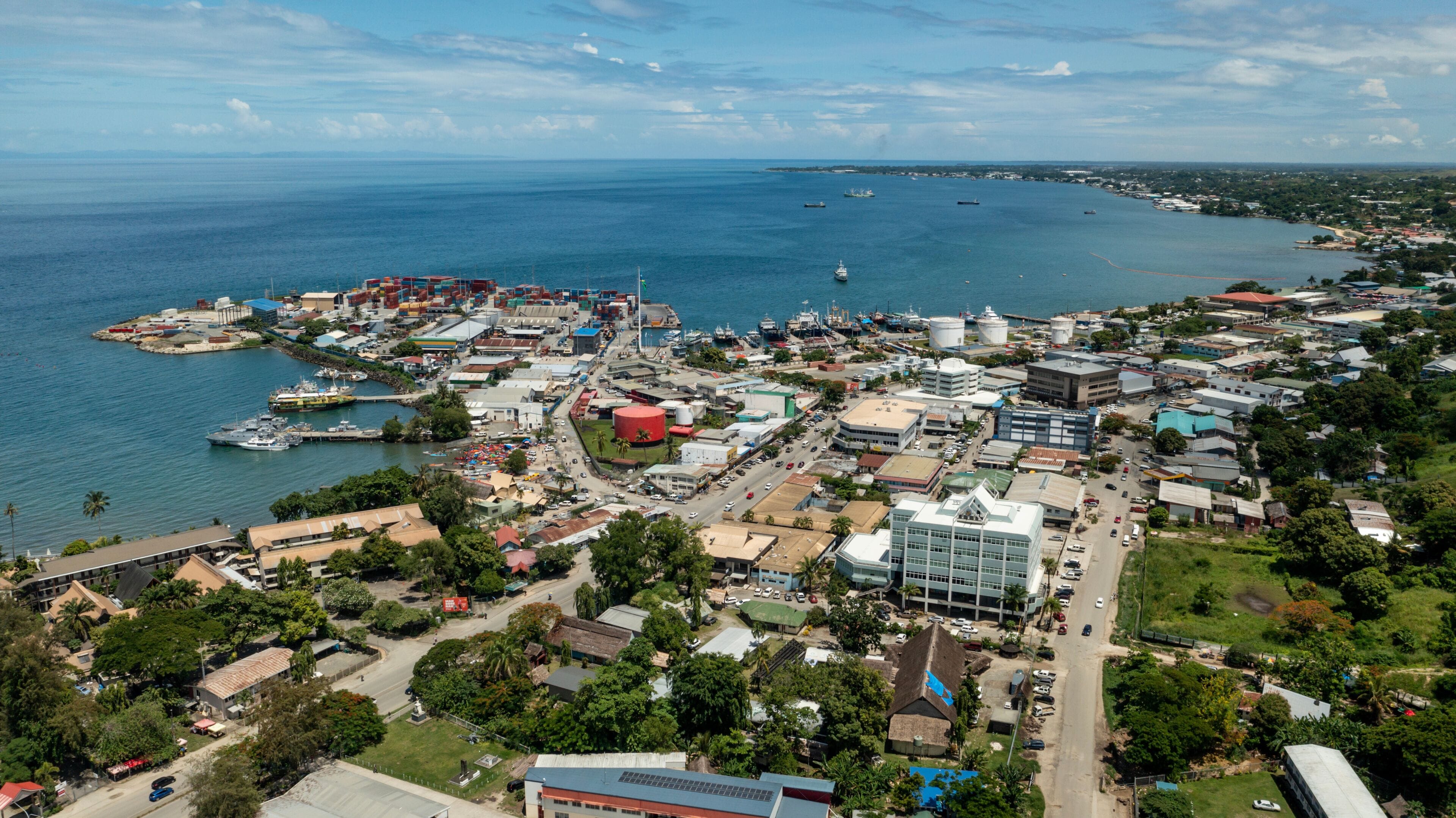 A coastal city with a harbor, industrial buildings, and a mix of residential and commercial structures.