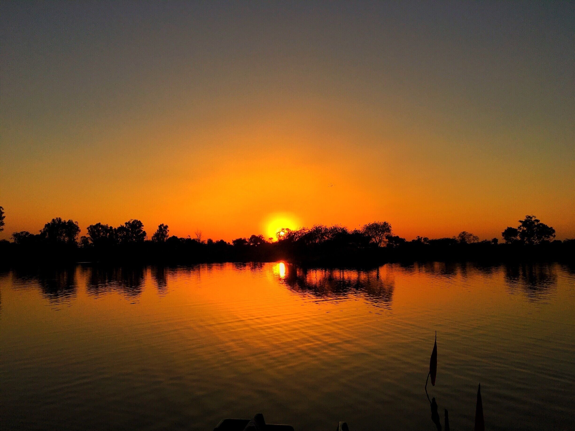 With the western group of temples towering over the surroundings and Shivsagar lake acting as the perfect mirror, it was such a magnificent sight to witness the sunset. 
Large number of people had gathered on the stairs, staring at the setting sun and soaking all, that the city of Khajuraho had to offer. #Red