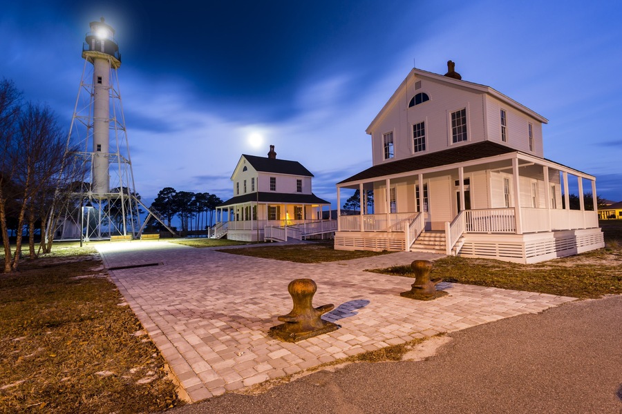 Beautiful old lighthouse being lit by a full moon just before dawn #BVSBLUE