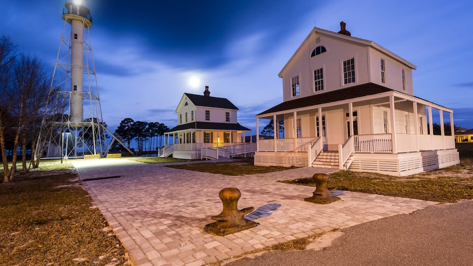 Beautiful old lighthouse being lit by a full moon just before dawn #BVSBLUE