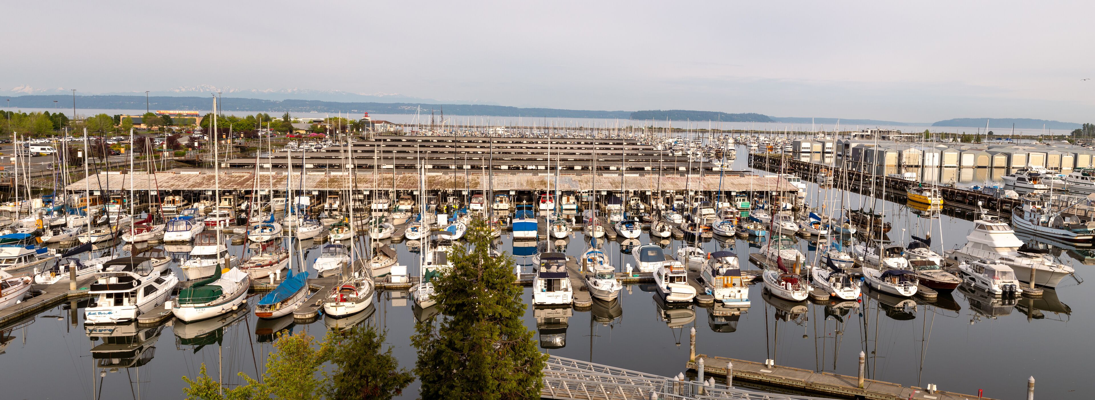 A marina filled with various boats docked at the pier.