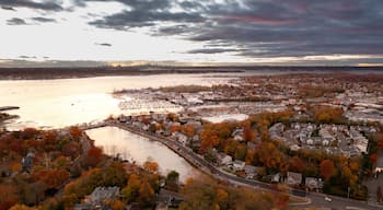 A coastal town with autumn foliage, a marina, and a river.