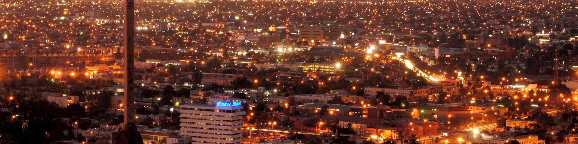 Cross with cityscape at night in Hermosillo, Sonora, Mexico.