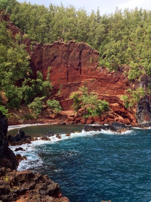 On the back side of Ka'uiki Hill in Hana, Red Sand (Kaihalulu) Beach is just a five minute hike, but steep drop offs and loose gravel from this cinder cone make it a treacherous trip. Not for the faint of heart or perpetually clumsy, but daring adventurers are rewarded with dramatic red cliffs and a cerulean blue cove providing a sheltered swimming area.