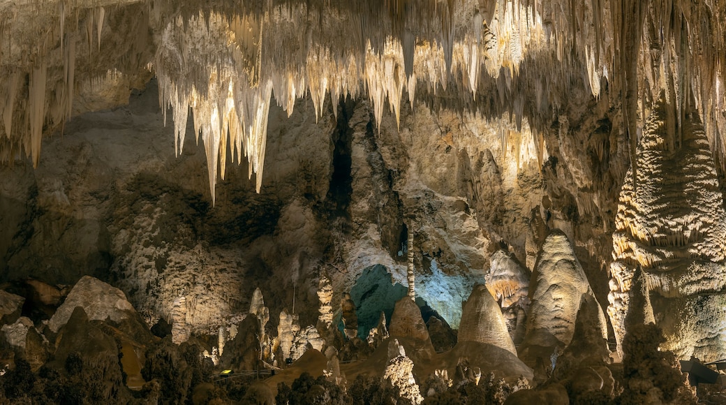 A cave with stalactites hanging from the ceiling and stalagmites rising from the ground.