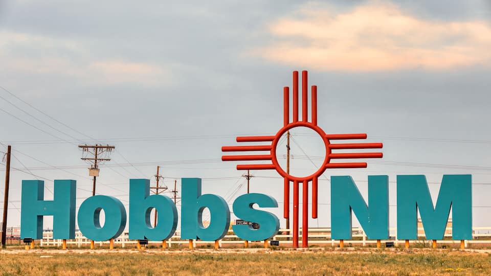 A large sign with 'Hobbs NM' and a sun-like symbol.