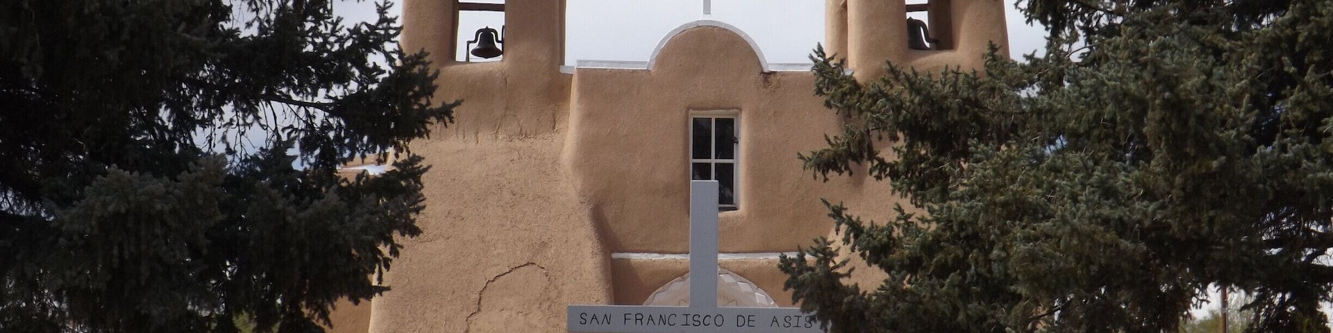 San Francisco is one of the most photographed Spanish Colonial churches in the USA. It has twin bell towers, an arched portal entrance overlooking an enclosed courtyard, two large carved and painted reredos (alter screens with painted panels), hand-hewn vigas (ceiling beams( that rest on hand-carved corbels, and unique architectural buttresses.