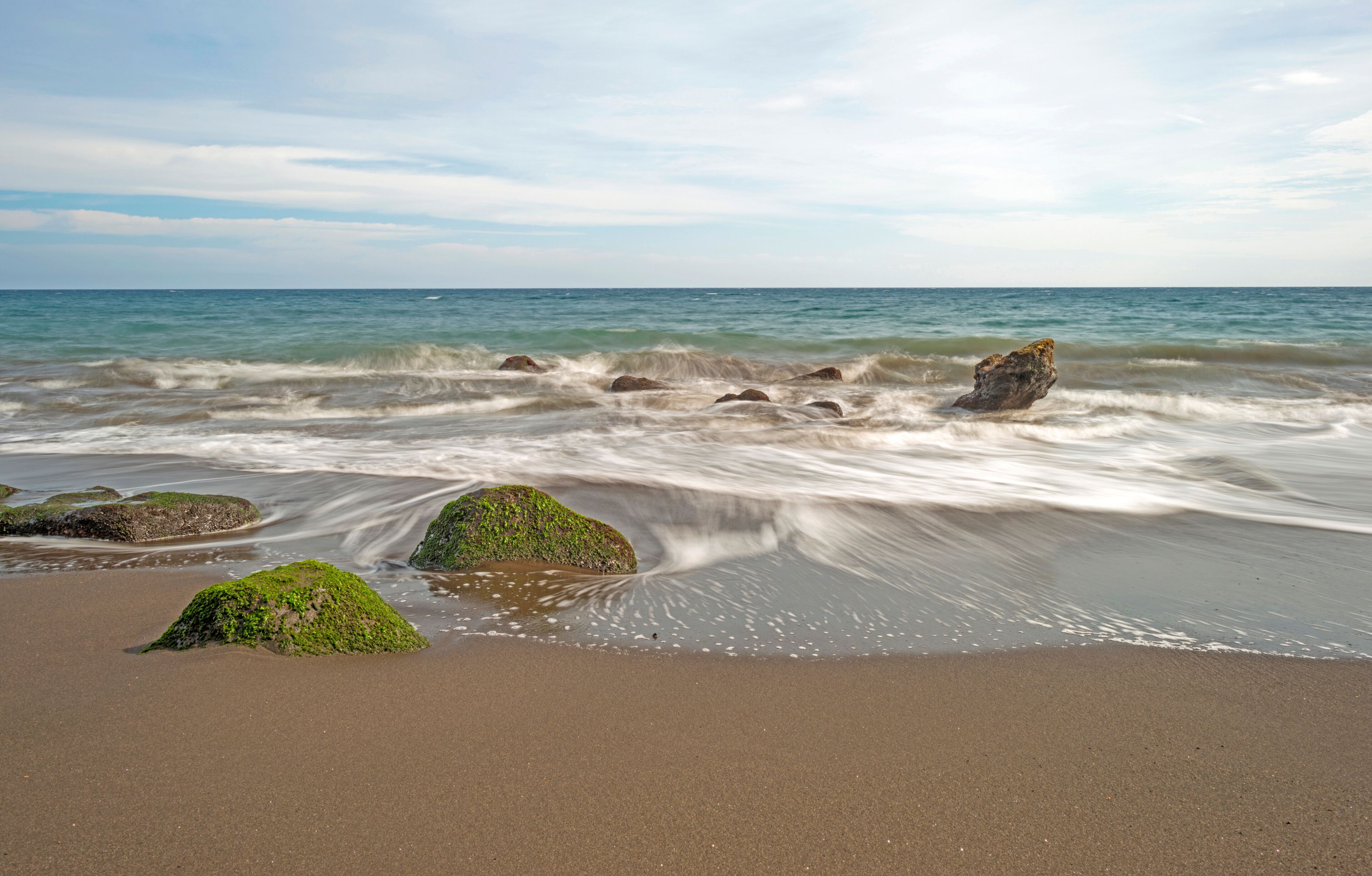 Waves on a rocky beach in slow motion
