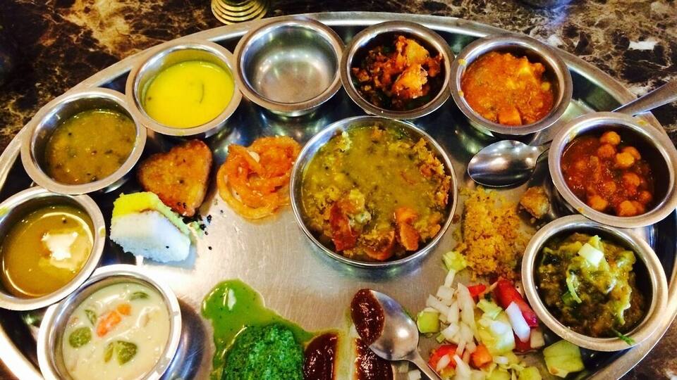 A traditional Indian thali with various dishes.