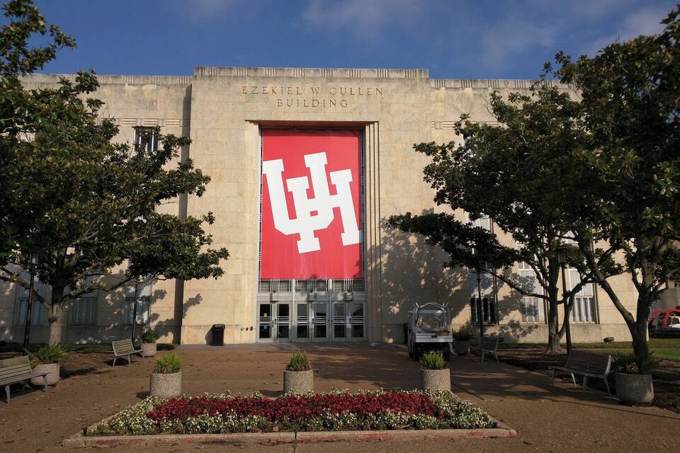The exterior of the Ezekiel W. Cullen Building with a large red banner featuring a white letter 'W'.