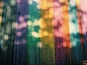 A colorful, abstract pattern with vertical lines and streaks of various colors.