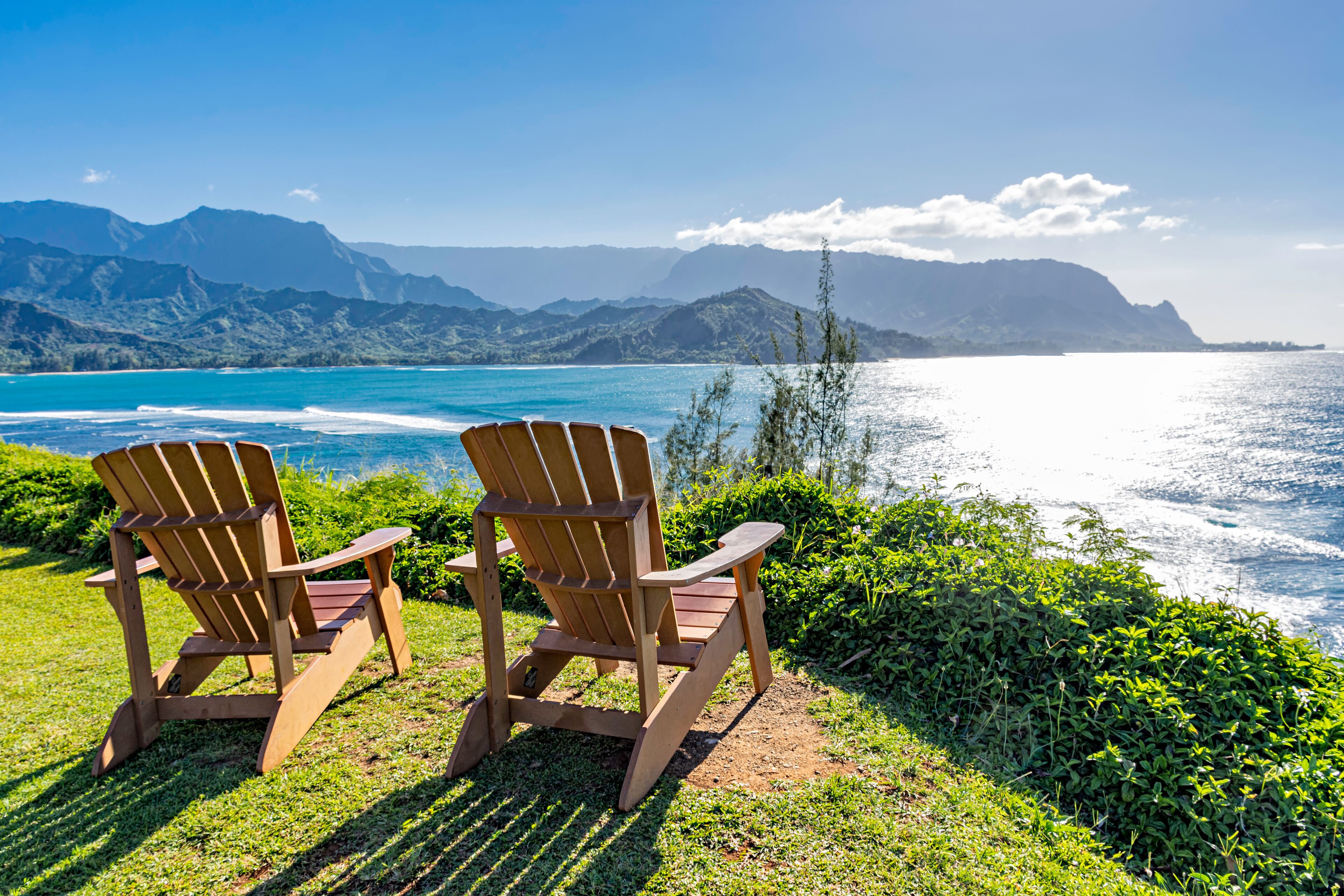 lounging chairs overlooking Hanalei Bay and the Na Pali coast Princeville Kauai Hawaii USA