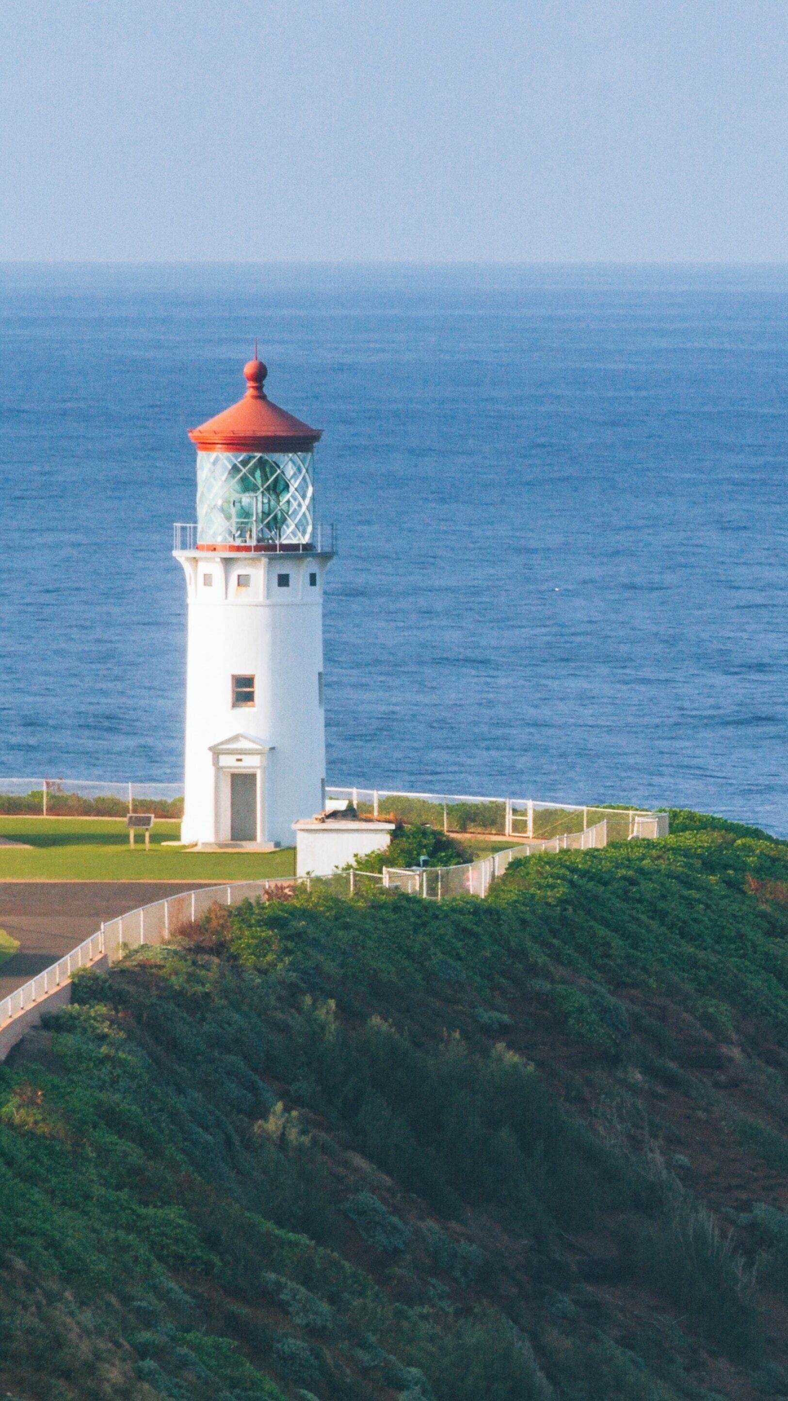 Kilauea Lighthouse towers above the ocean in Princeville, Hawaii, guiding boats with its historic light