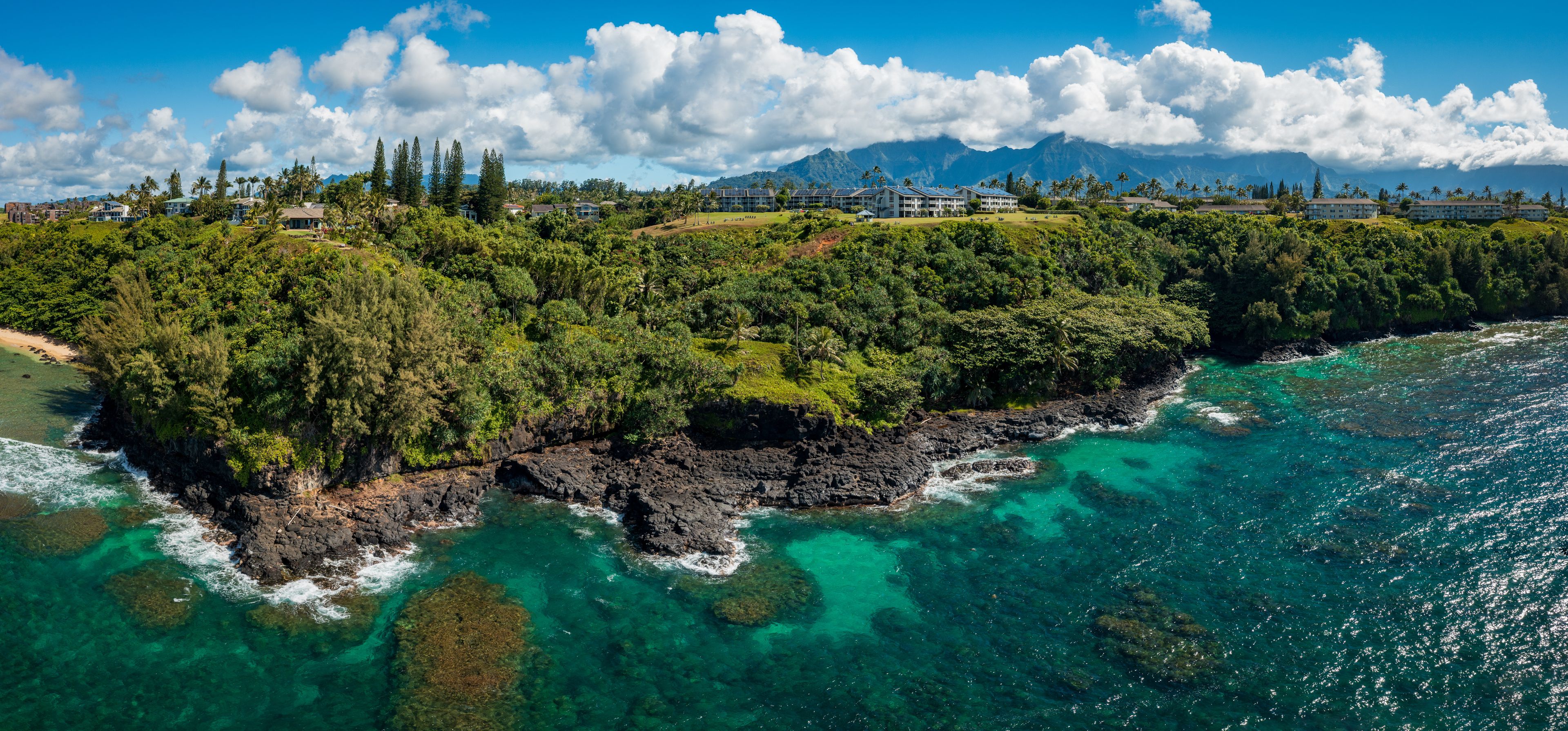 Aerial offshore view of the coast west of Sealodge beach in Princeville on the north coast of Kauai