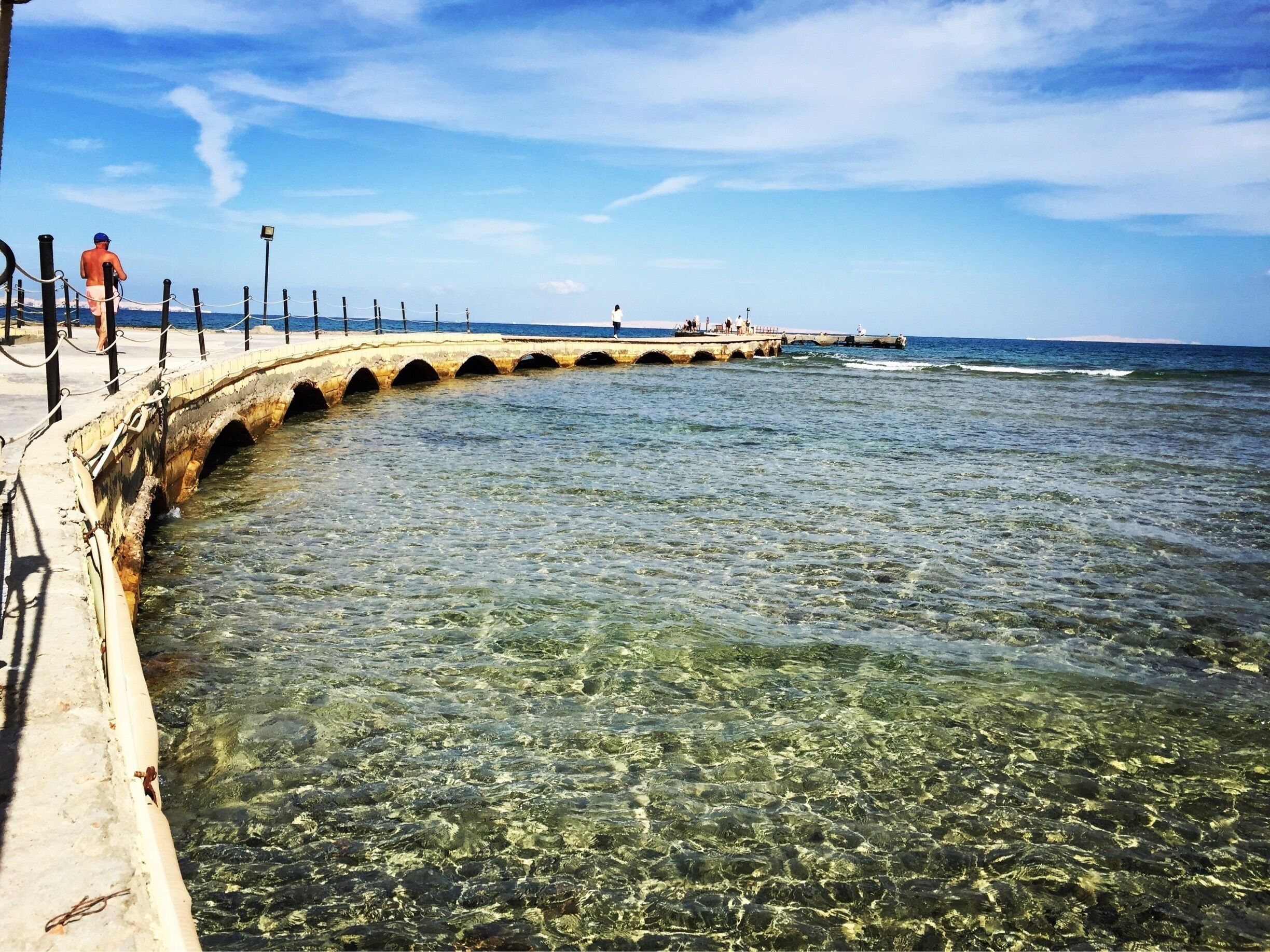This pier comes from the hotel beach and is really shallow water. On a calm day you can see tropical fish just by standing at the end where the water is only about 2 meters deep. It became our regular morning walk after breakfast. 