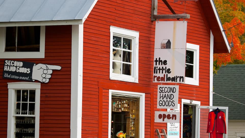 A red building with signs for 'Second Hand Goods' and 'The Little Red Barn'.