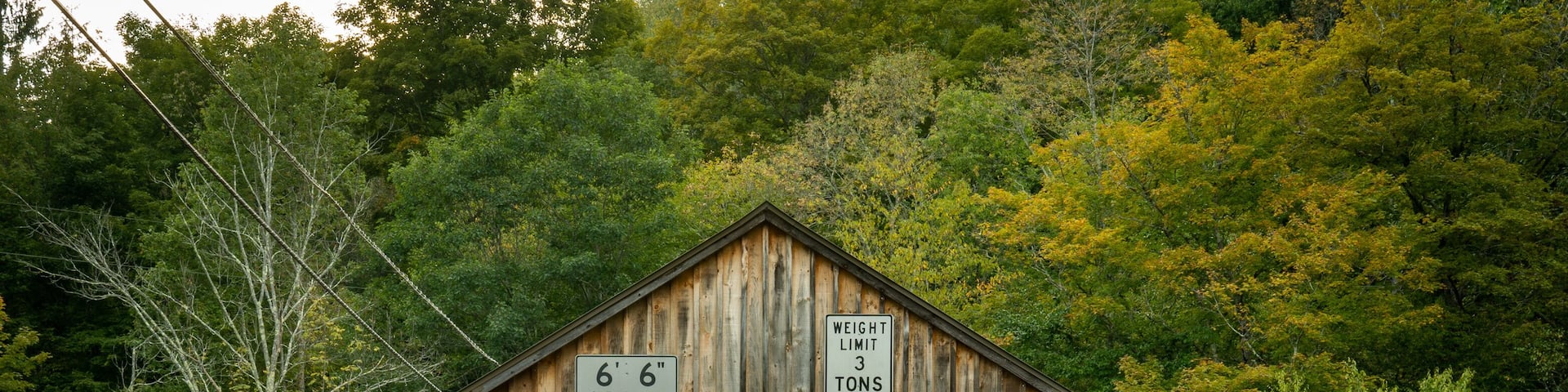Roscoe, NY - USA - Sept 17, 2022 Horizontal view of the entrance to the Beaverkill Covered Bridge, also known as the Conklin Bridge, a wooden covered bridge over the Beaver Kill.